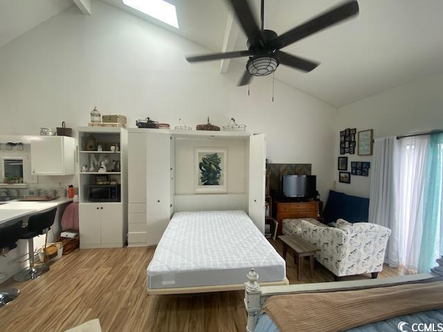 1891 Colony Dr Unit 14-O, Surfside Beach, SC 29575 - bedroom featuring light wood finished floors, high vaulted ceiling, beam ceiling, and ceiling fan