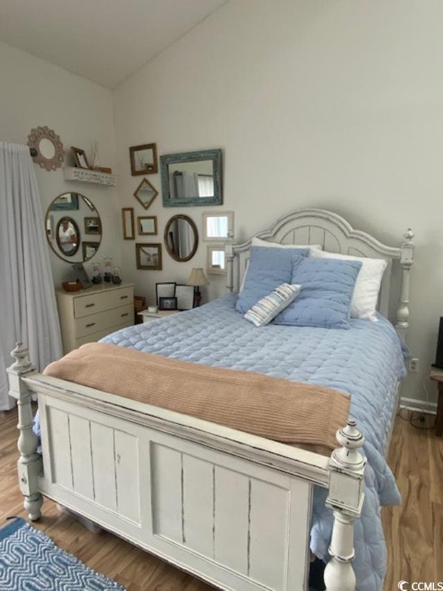1891 Colony Dr Unit 14-O, Surfside Beach, SC 29575 - bedroom with vaulted ceiling and wood finished floors