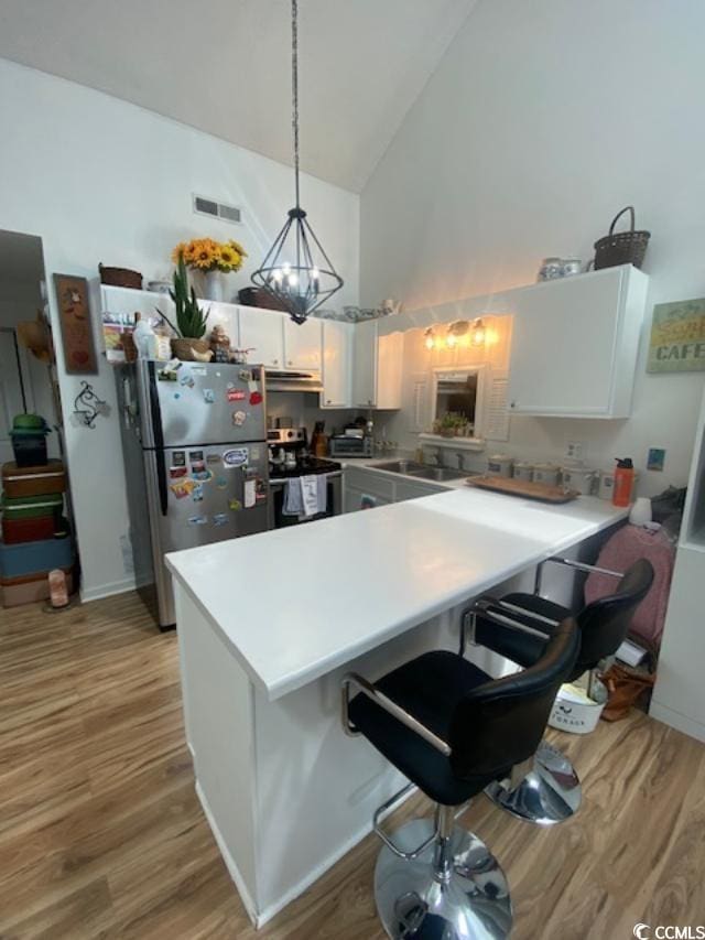 1891 Colony Dr Unit 14-O, Surfside Beach, SC 29575 - kitchen with stainless steel appliances, high vaulted ceiling, a peninsula, white cabinetry, and a sink