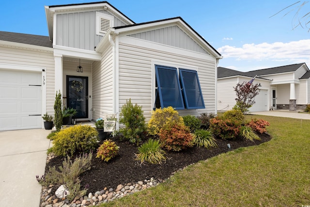179 S Reindeer Rd, Surfside Beach, SC 29575 - view of front facade with board and batten siding, an attached garage, driveway, and a front lawn
