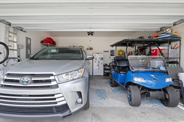 179 S Reindeer Rd, Surfside Beach, SC 29575 - garage featuring electric panel and a garage door opener
