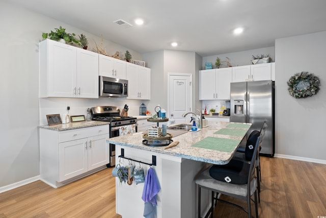 179 S Reindeer Rd, Surfside Beach, SC 29575 - kitchen featuring light wood finished floors, stainless steel appliances, visible vents, and a sink