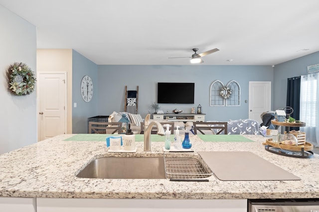 179 S Reindeer Rd, Surfside Beach, SC 29575 - kitchen with ceiling fan, stainless steel dishwasher, open floor plan, and light stone counters