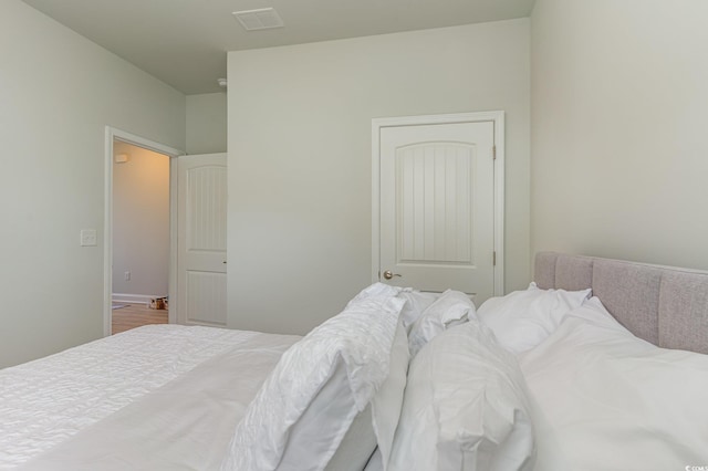 bedroom with wood finished floors and visible vents