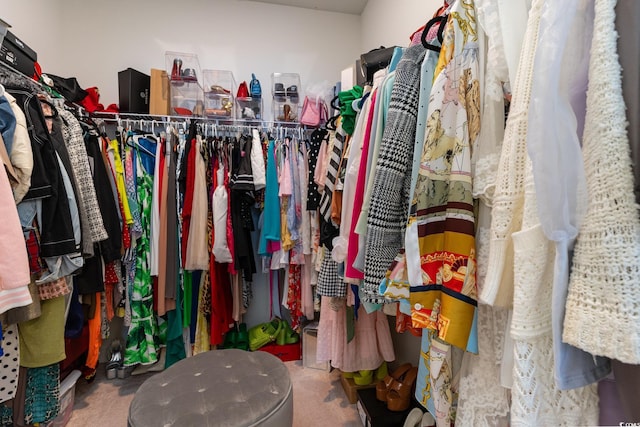 walk in closet with carpet flooring