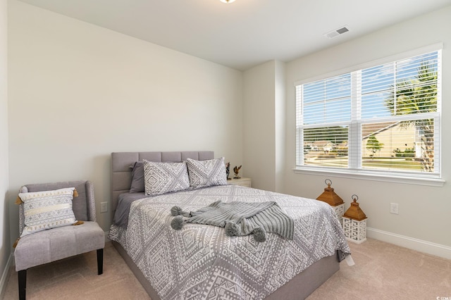 carpeted bedroom with baseboards and visible vents