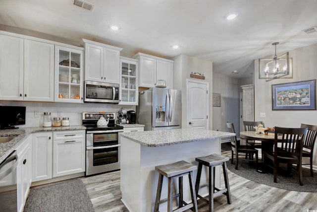830 San Marco Ct Unit 2603-B, Myrtle Beach, SC 29579 - kitchen featuring appliances with stainless steel finishes, white cabinetry, light wood-type flooring, and visible vents