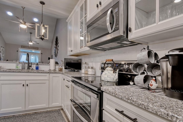 830 San Marco Ct Unit 2603-B, Myrtle Beach, SC 29579 - kitchen featuring white cabinets, stainless steel appliances, a sink, decorative backsplash, and ceiling fan with notable chandelier