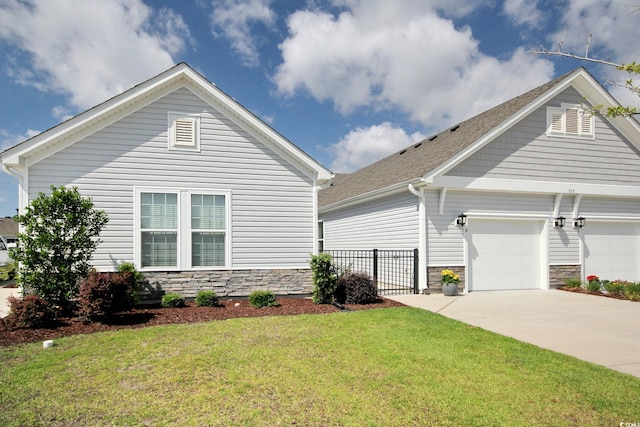 830 San Marco Ct Unit 2603-B, Myrtle Beach, SC 29579 - view of front of home with concrete driveway, stone siding, a front yard, an attached garage, and fence