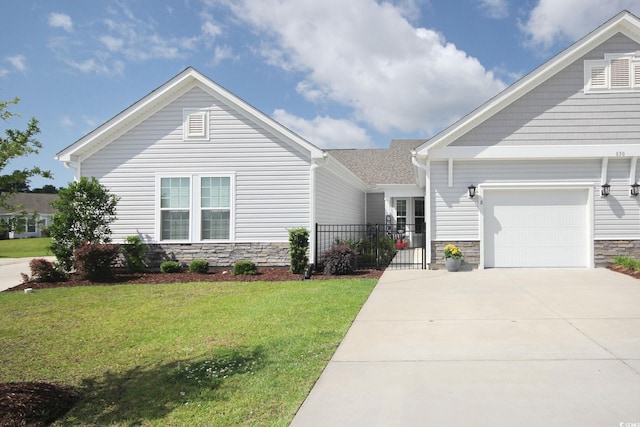 830 San Marco Ct Unit 2603-B, Myrtle Beach, SC 29579 - view of front of house featuring a front yard, a garage, driveway, stone siding, and fence