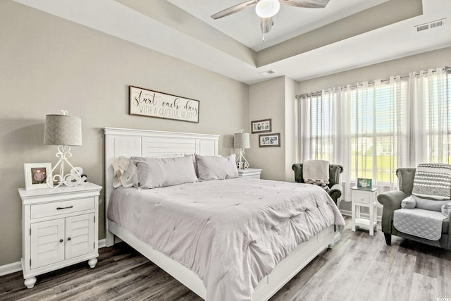 830 San Marco Ct Unit 2603-B, Myrtle Beach, SC 29579 - bedroom featuring a tray ceiling, wood finished floors, visible vents, a ceiling fan, and baseboards