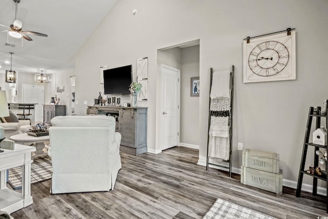 830 San Marco Ct Unit 2603-B, Myrtle Beach, SC 29579 - living area with high vaulted ceiling, visible vents, baseboards, wood finished floors, and ceiling fan with notable chandelier