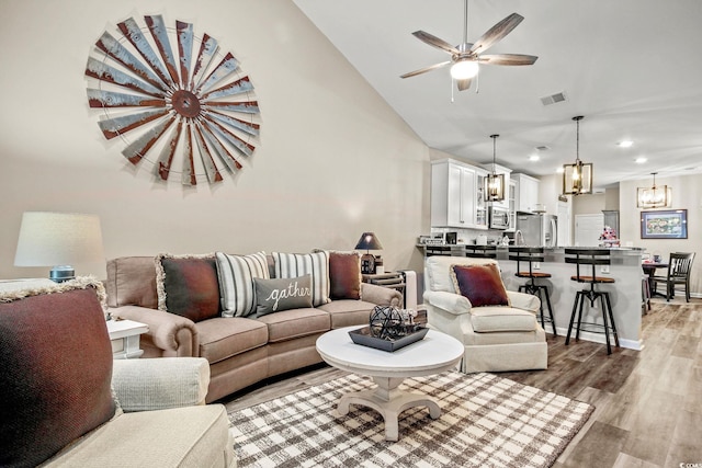830 San Marco Ct Unit 2603-B, Myrtle Beach, SC 29579 - living area featuring high vaulted ceiling, ceiling fan with notable chandelier, light wood finished floors, visible vents, and recessed lighting