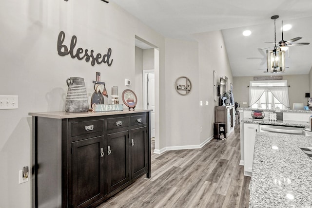 830 San Marco Ct Unit 2603-B, Myrtle Beach, SC 29579 - kitchen featuring a ceiling fan, light wood finished floors, baseboards, lofted ceiling, and light stone countertops