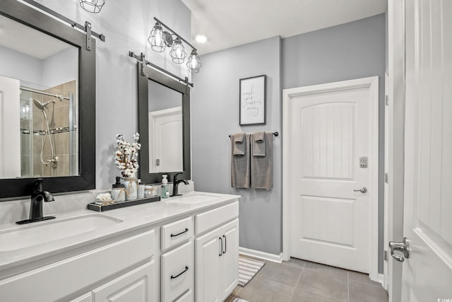 830 San Marco Ct Unit 2603-B, Myrtle Beach, SC 29579 - bathroom with double vanity, a shower stall, tile patterned flooring, and a sink
