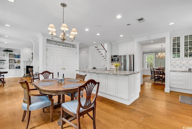 486 Lantana Cir, Georgetown, SC 29440 - dining space featuring a chandelier, light wood finished floors, stairs, and recessed lighting