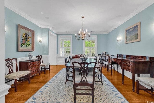 486 Lantana Cir, Georgetown, SC 29440 - dining space with a chandelier, wood finished floors, and crown molding