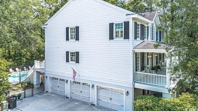 486 Lantana Cir, Georgetown, SC 29440 - view of side of property with an attached garage, a shingled roof, and concrete driveway