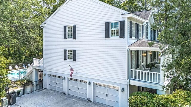 486 Lantana Cir, Georgetown, SC 29440 - view of side of property with an attached garage, a shingled roof, and concrete driveway