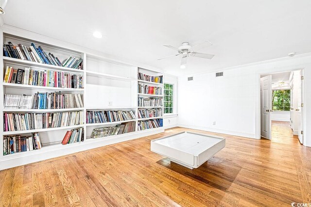 486 Lantana Cir, Georgetown, SC 29440 - living area featuring wood finished floors, crown molding, a ceiling fan, baseboards, and built in features