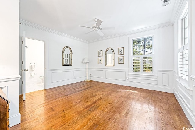 486 Lantana Cir, Georgetown, SC 29440 - spare room featuring a ceiling fan, hardwood / wood-style flooring, crown molding, a wainscoted wall, and a decorative wall
