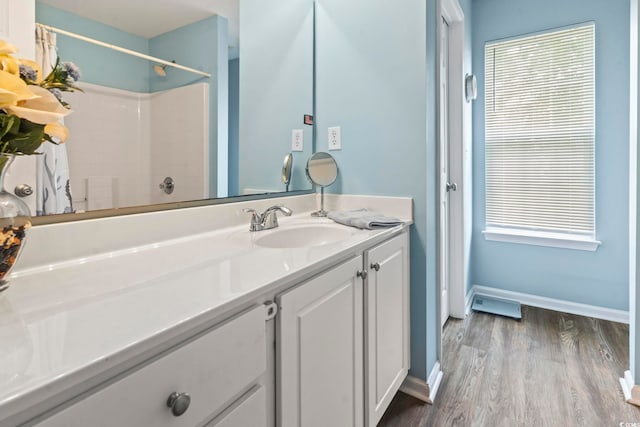 216 Whitchurch St, Murrells Inlet, SC 29576 - bathroom featuring vanity, baseboards, wood finished floors, and a shower