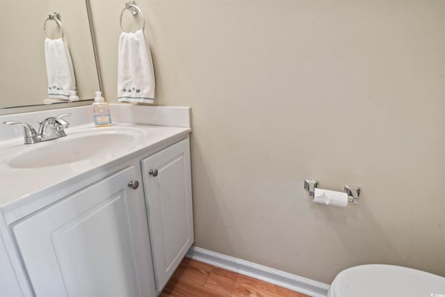 216 Whitchurch St, Murrells Inlet, SC 29576 - half bathroom featuring toilet, baseboards, wood finished floors, and vanity