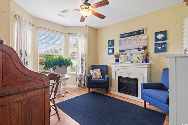 216 Whitchurch St, Murrells Inlet, SC 29576 - sitting room featuring a fireplace, a ceiling fan, wood finished floors, and visible vents