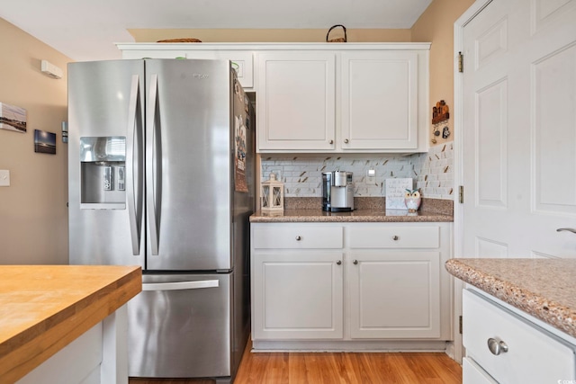 216 Whitchurch St, Murrells Inlet, SC 29576 - kitchen featuring stainless steel fridge, tasteful backsplash, light wood finished floors, and white cabinetry