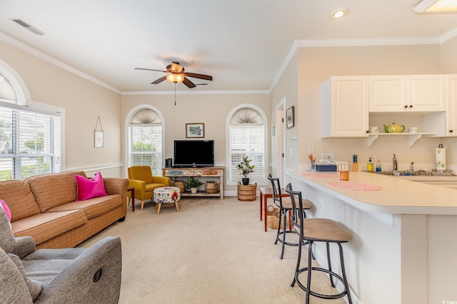 4709 Wild Iris Dr Unit 101, Myrtle Beach, SC 29577 - living room featuring ornamental molding, a ceiling fan, visible vents, and light carpet