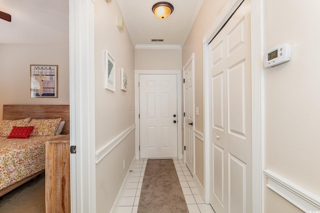 4709 Wild Iris Dr Unit 101, Myrtle Beach, SC 29577 - hallway featuring light tile patterned floors, ornamental molding, baseboards, visible vents, and a textured ceiling