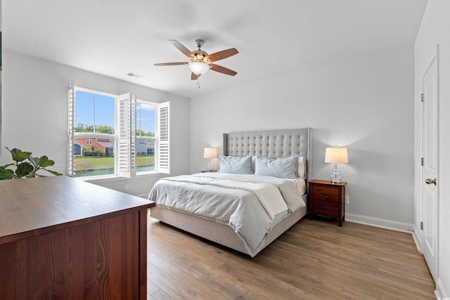2620 Blue Crane Cir Unit 103, Myrtle Beach, SC 29577 - bedroom featuring wood finished floors, baseboards, and ceiling fan