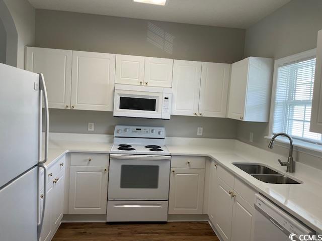 5825 Catalina Dr Unit 234, North Myrtle Beach, SC 29582 - kitchen with white cabinets, dark wood-type flooring, a sink, and white appliances