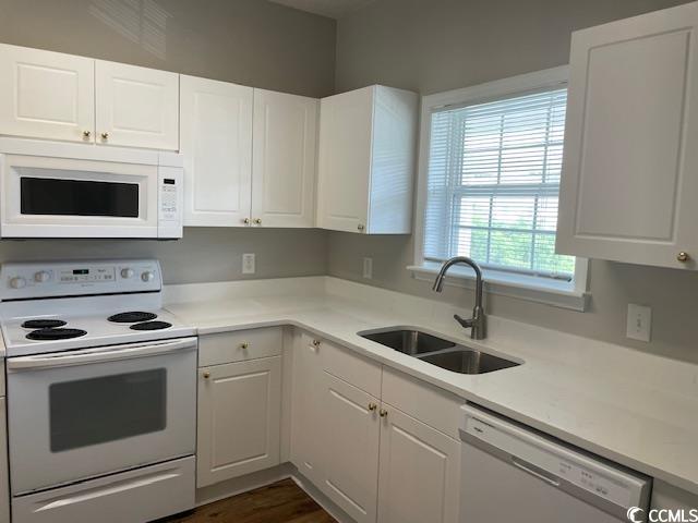 5825 Catalina Dr Unit 234, North Myrtle Beach, SC 29582 - kitchen with light countertops, white cabinetry, a sink, and white appliances
