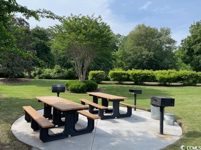 5825 Catalina Dr Unit 234, North Myrtle Beach, SC 29582 - view of home's community with a yard, a patio area, and outdoor dining space
