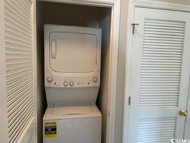 5825 Catalina Dr Unit 234, North Myrtle Beach, SC 29582 - laundry area featuring stacked washer and clothes dryer and laundry area