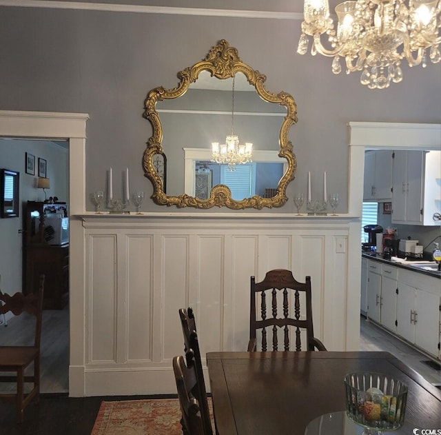 dining space with a chandelier and wood finished floors