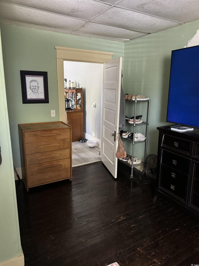 bedroom featuring wood-type flooring and baseboards