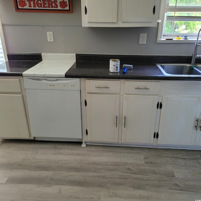 kitchen featuring white cabinetry, a sink, light wood finished floors, and dishwasher