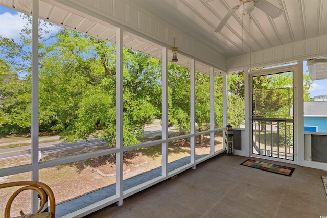 unfurnished sunroom with a ceiling fan