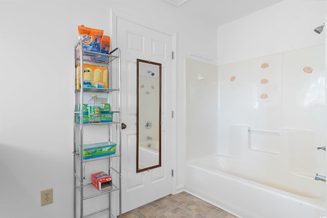 full bathroom with bathtub / shower combination, baseboards, and brick patterned flooring