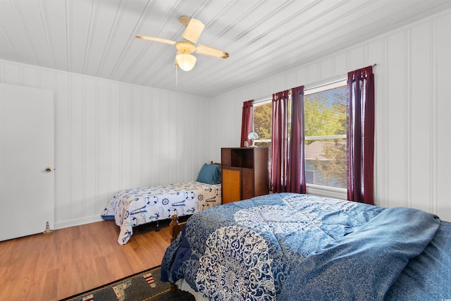 bedroom featuring wood finished floors, a ceiling fan, and wooden ceiling