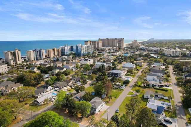 aerial view of property's location with nearby urban area and a large body of water