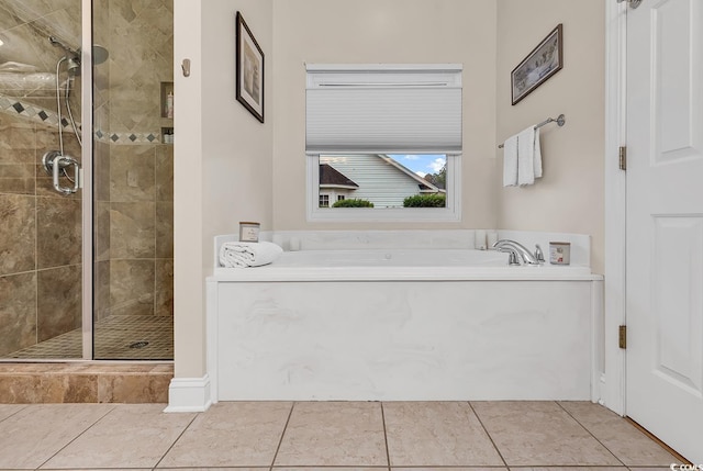 bathroom with tile patterned flooring, a bath, and a stall shower