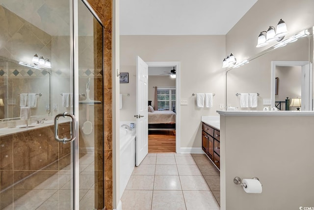 full bathroom with tile patterned flooring, vanity, a ceiling fan, a shower stall, and ensuite bathroom