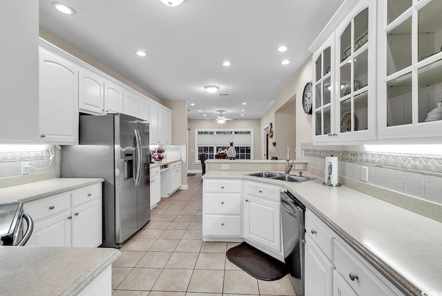 kitchen with decorative backsplash, dishwasher, and light tile patterned flooring