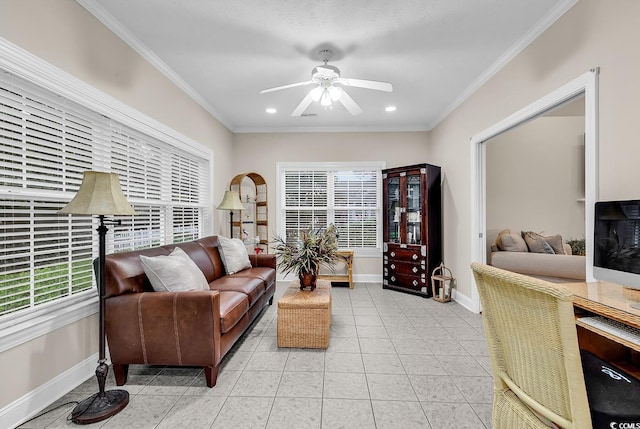 tiled living room with a ceiling fan, baseboards, recessed lighting, and ornamental molding
