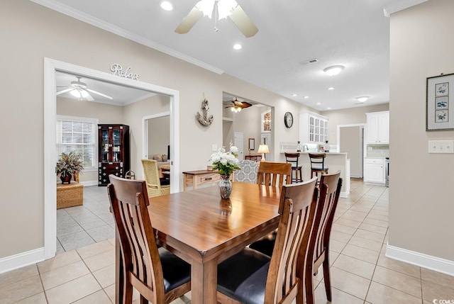 dining area featuring light tile patterned floors, baseboards, ceiling fan, and visible vents