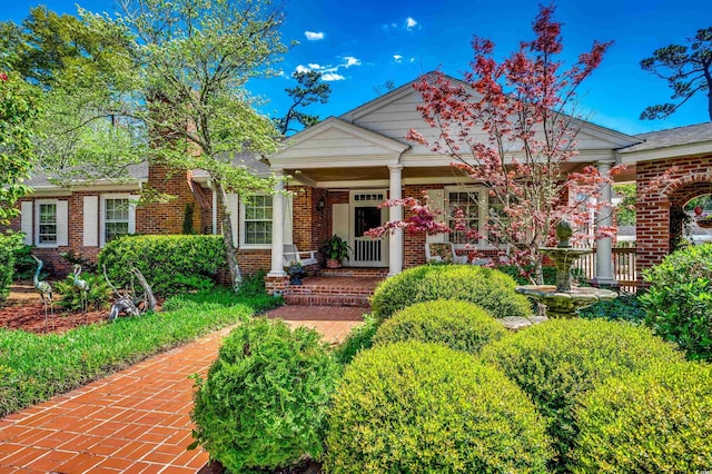 view of front of property featuring a porch and brick siding