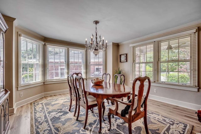 dining space featuring an inviting chandelier, baseboards, and a wealth of natural light